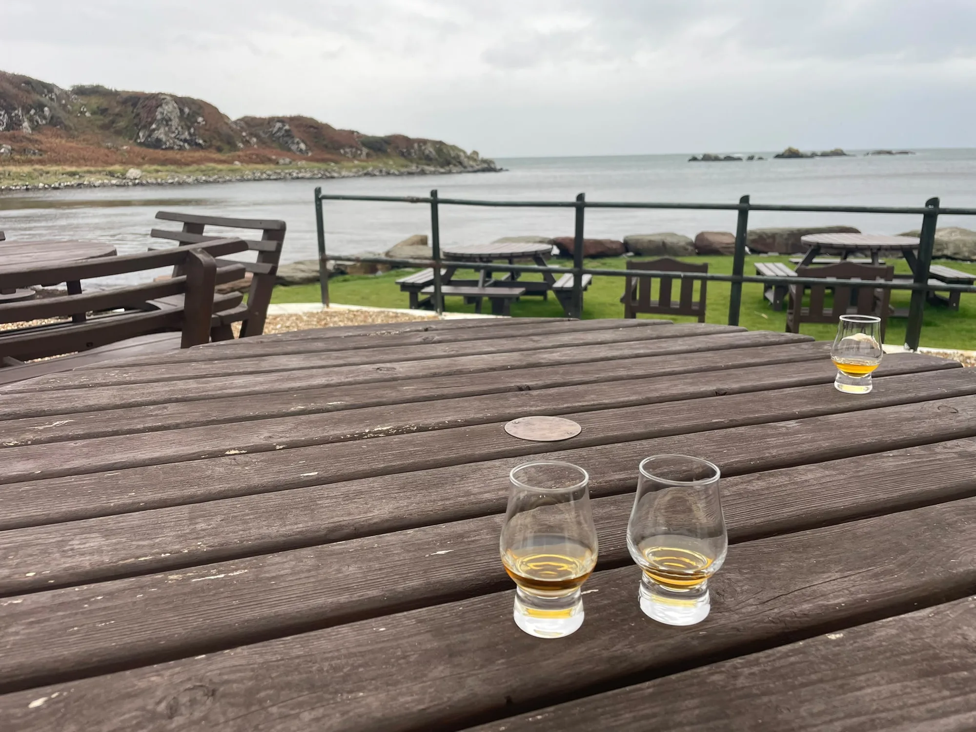 Whisky glasses by the sea at Laphroaig